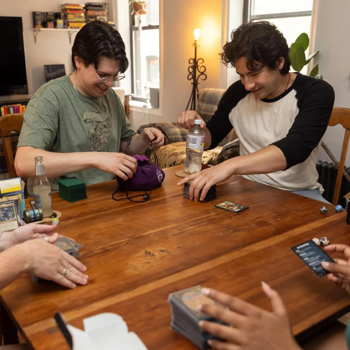 (Clockwise from left) Shea Dunlop and her boyfriend Nick Lamberti host their friends Leo Lerner and Yenilet Rodriguez to fun and games at their home.