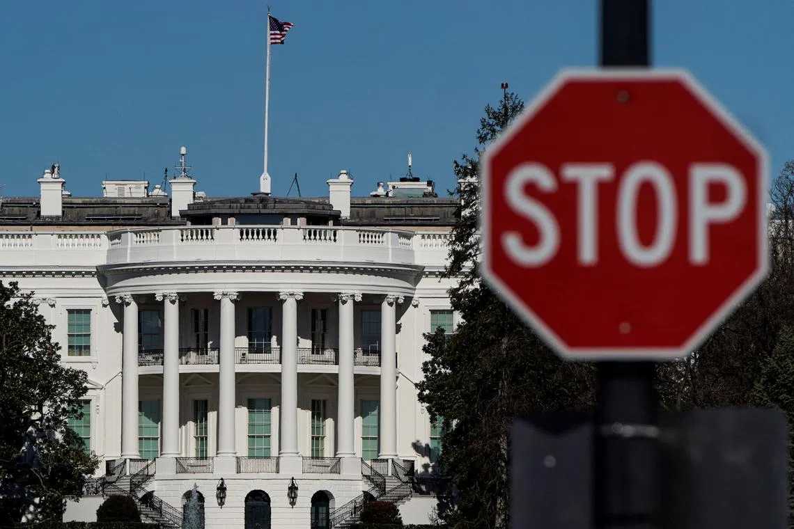 FILE PHOTO: The White House is seen behind a stop sign in Washington, U.S., January 10, 2021.  REUTERS/Joshua Roberts/File Photo