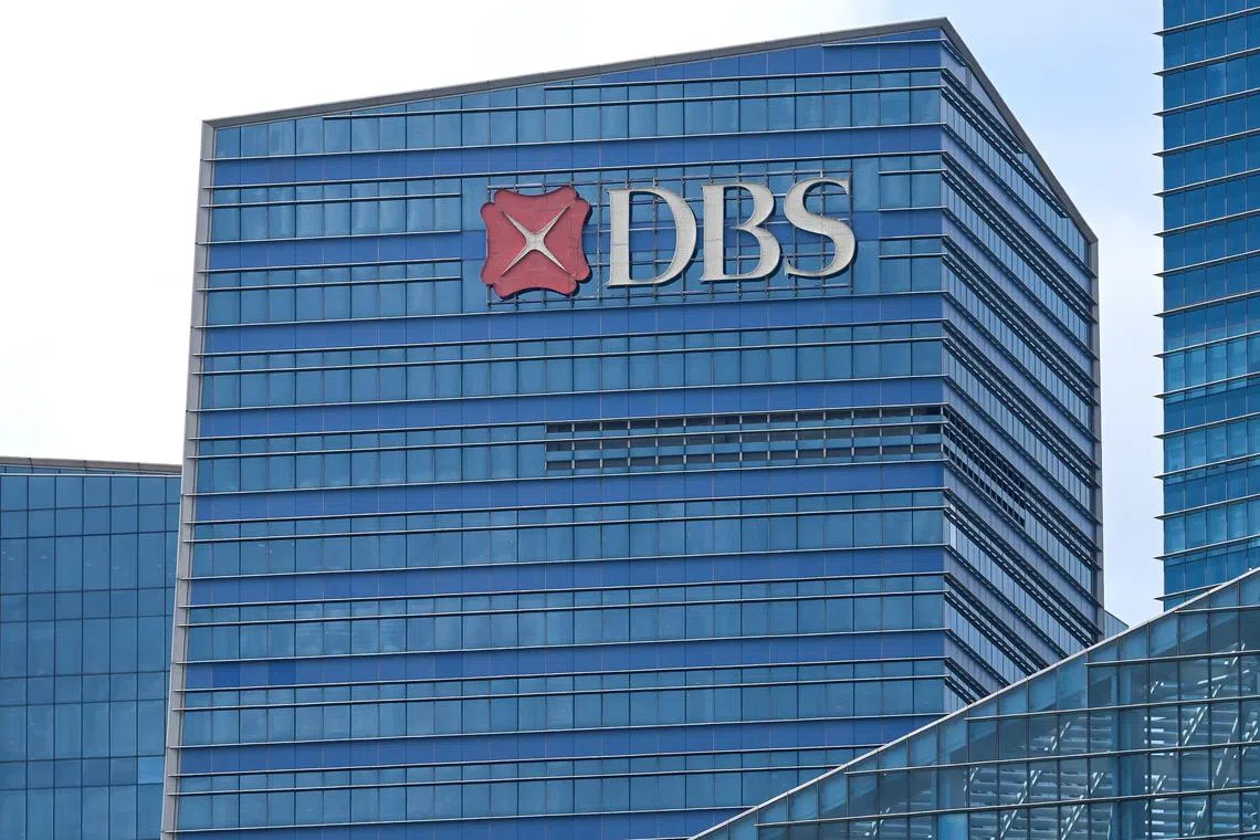 A Development Bank of Singapore (DBS) company signage is seen on a building facade at the central business district in Singapore on March 14, 2025. (Photo by Roslan RAHMAN / AFP)