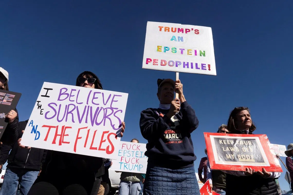 Protesters hold signs outside Zorro Ranch, a property formerly owned by Jeffrey Epstein, on International Women’s Day near Stanley, New Mexico, U.S. March 8, 2026.  REUTERS/Rebecca Noble
