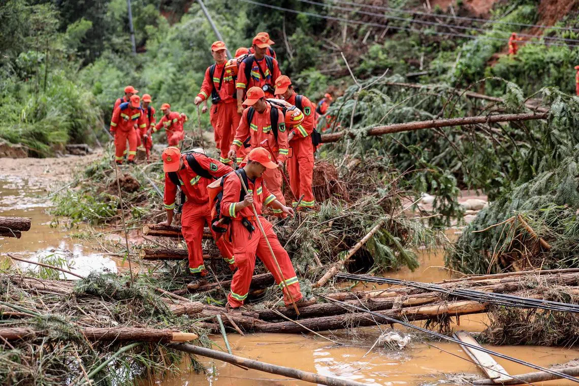 Rescuers navigate a flood-affected area in Zixing city, where seven people died due to heavy rain and flooding.