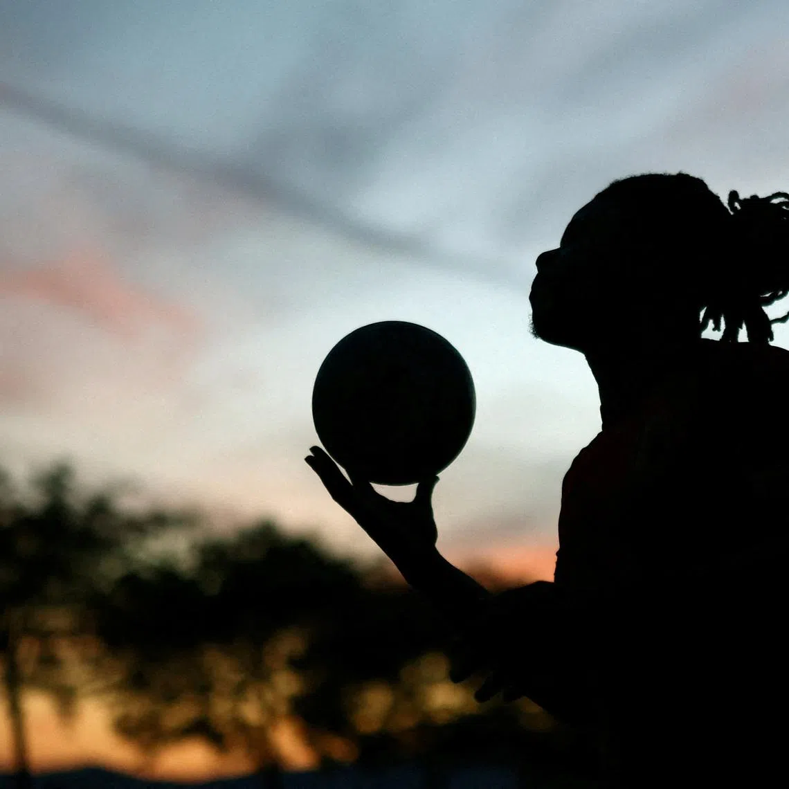 FILE PHOTO: Soccer Football - FIFA World Cup 2026 - Sunset Beach FC holds a street football match - Sunset Beach, Vancouver, Canada - June 22, 2026 A player participates in the community run weekly street football held at a asphalt hockey rink  REUTERS/Lee Smith/File Photo
