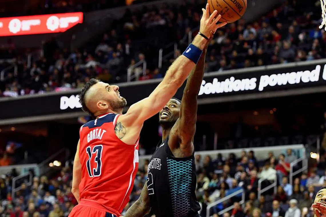 FILE PHOTO: Feb 23, 2018; Washington, DC, USA; Washington Wizards center Marcin Gortat (13) battles Charlotte Hornets center Dwight Howard (12) for the ball during the first half at Capital One Arena. Mandatory Credit: Brad Mills-USA TODAY Sports/File Photo