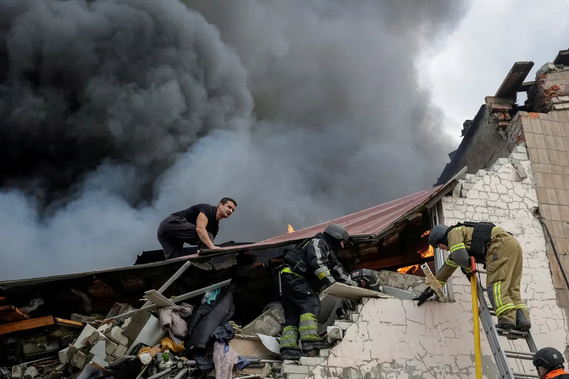 Rescuers work at a site of a building of a sewing factory damaged by a Russian air strike, amid Russia's attack on Ukraine in Kharkiv, Ukraine October 5, 2026. REUTERS/Sofiia Gatilova TPX IMAGES OF THE DAY
