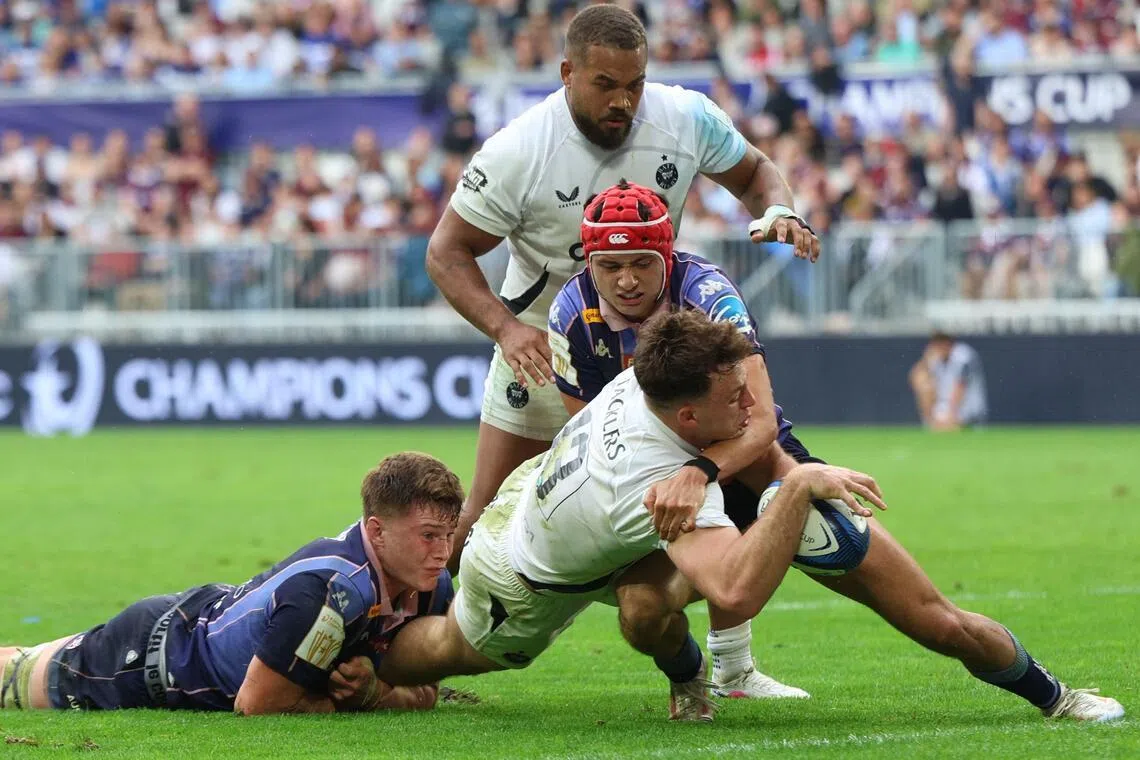 Bath's Welsh centre Louie Hennessey is tackled by Bordeaux-Begles' French full-back Louis Bielle-Biarrey as he goes for a try in the European Champions Cup semi-final at the Atlantique Bordeaux Metropole Stadium in Bordeaux on May 3, 2026.