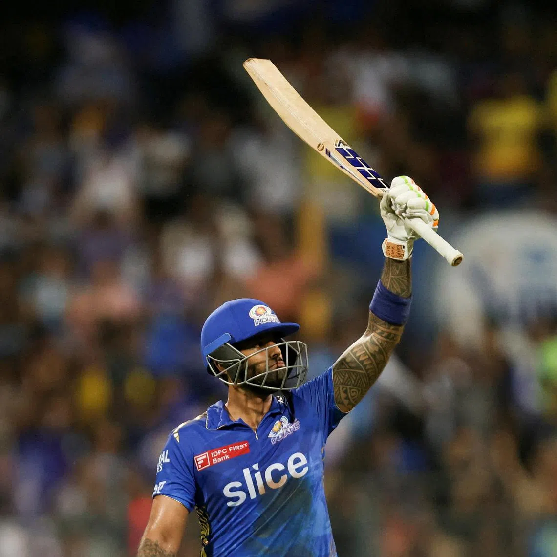 Mumbai Indians' Suryakumar Yadav raising his bat after scoring a half century against Royal Challengers Bangalore in an Indian Premier League cricket match in May.