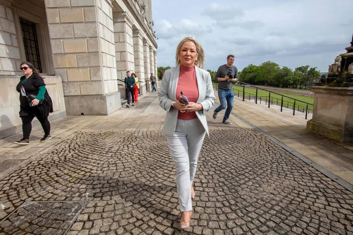 (FILES) Northern Ireland's Deputy First Minister and Irish republican Sinn Fein party Northern Leader Michelle O'Neill walks outside the parliament on the Stormont Estate in Belfast, Northern Ireland, on May 13, 2022. Northern Ireland's pro-UK Democratic Unionist Party (DUP) blocked the restart of the British province's new assembly in Belfast, in protest at post-Brexit trade arrangements. (Photo by Paul Faith / AFP)