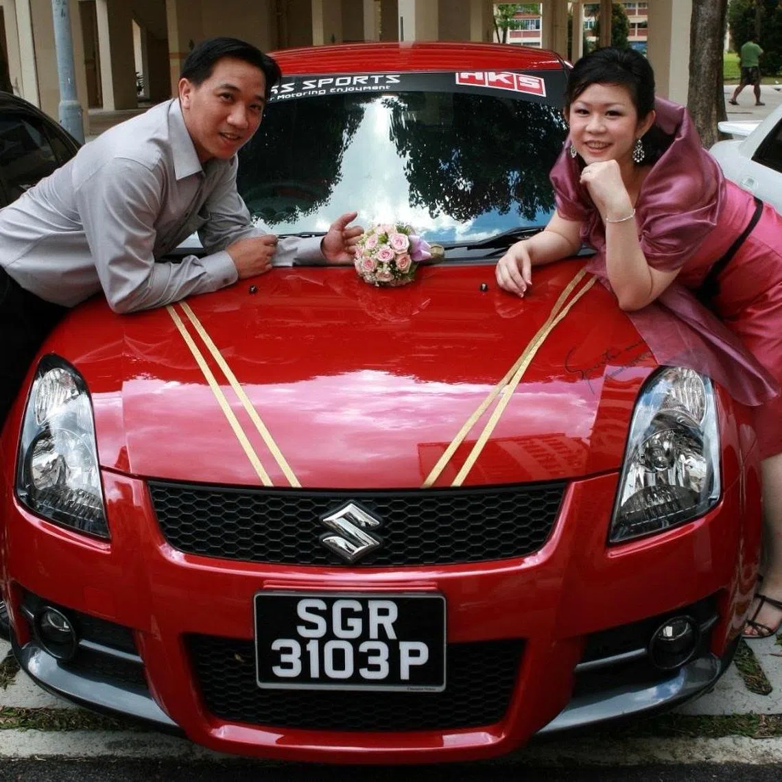 Mr Chase Lim and his wife Madam Chui Sufun with his Suzuki Swift Sport that was used as their wedding car on May 26, 2007.
