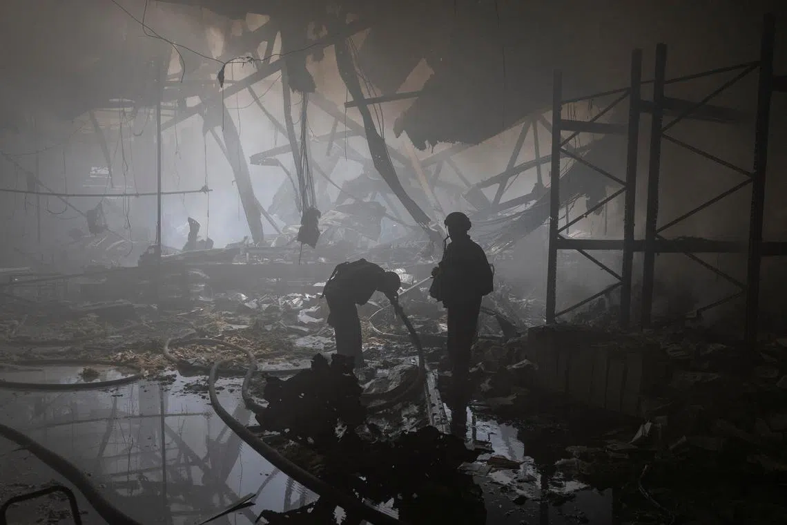 A firefighter washing up his face as he works at a compound of a printworks hit by Russian missile strikes, amid Russia's attack on Ukraine, in Kharkiv, Ukraine May 23, 2024. 