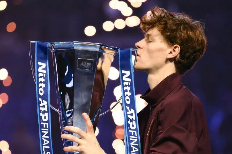 Italy's Jannik Sinner kisses the trophy after winning over Spain's Carlos Alcaraz at the end of the men's single final match at the ATP Finals. 