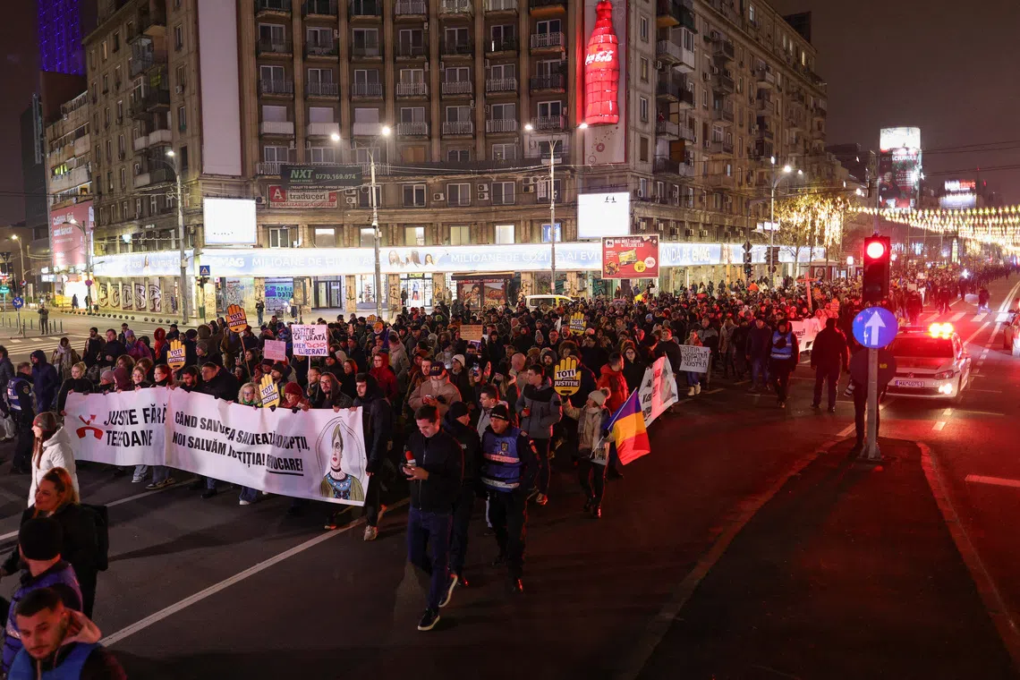People take part in a march in support of judges and prosecutors who denounced dysfunction and call for integrity and transparency in the Romanian justice system, in Bucharest, Romania, December 14, 2025. Inquam Photos/Octav Ganea via REUTERS