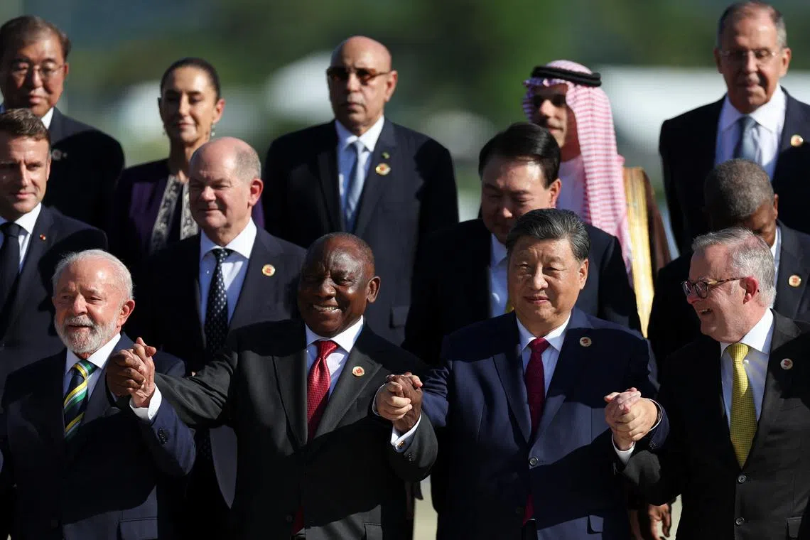 FILE PHOTO: Brazil's President Luiz Inacio Lula da Silva, South Africa's President Cyril Ramaphosa, China's President Xi Jinping, Australia's Prime Minister Anthony Albanese, French President Emmanuel Macron, German Chancellor Olaf Scholz, South Korea's President Yoon Suk Yeol, Japan's Prime Minister Shigeru Ishiba, Mexico's President Claudia Sheinbaum, Saudi Foreign Minister Prince Faisal bin Farhan Al-Saud and Russia's Foreign Minister Sergei Lavrov pose for a group photo accompanied by other leaders during the G20 summit in Rio de Janeiro, Brazil, November 18, 2024. REUTERS/Pilar Olivares/File Photo