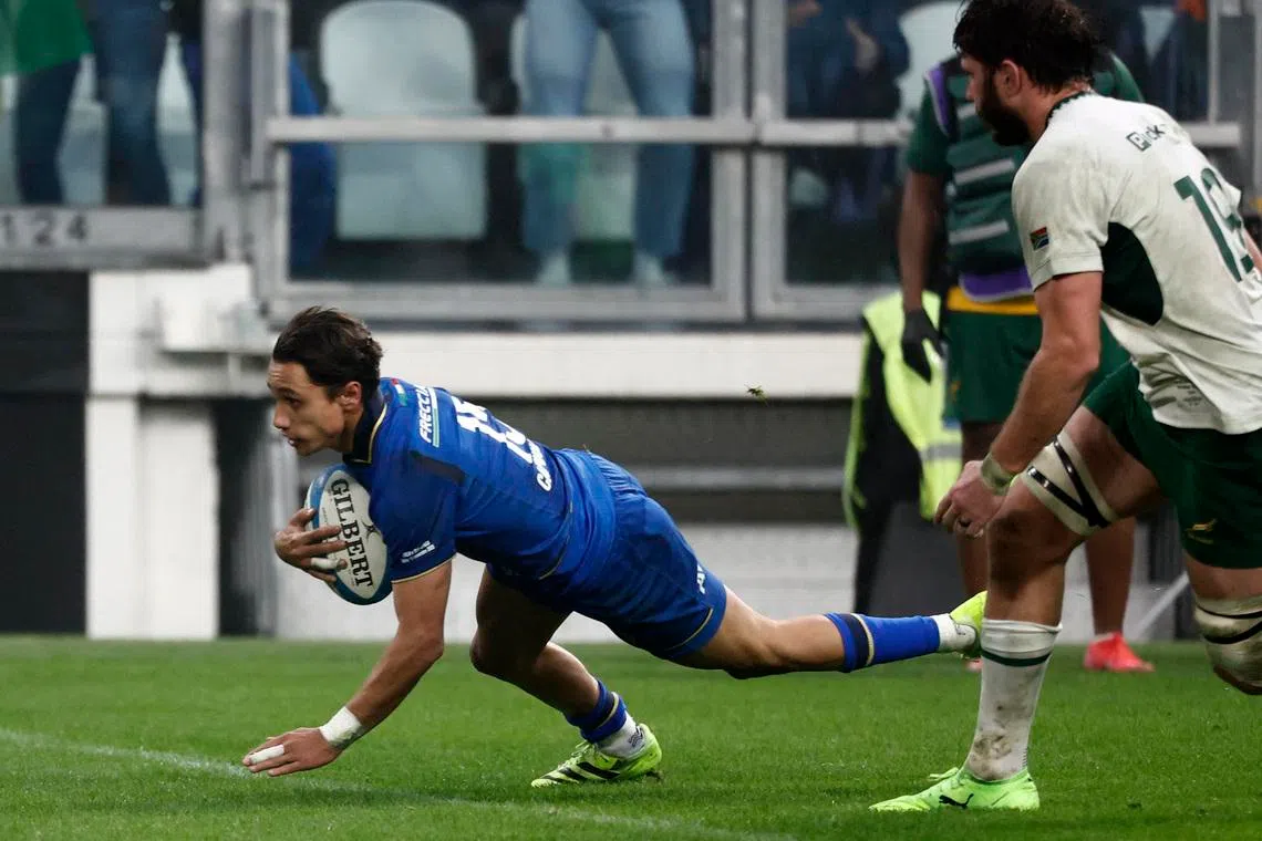 Rugby Union - Autumn Internationals - Italy v South Africa - Allianz Stadium, Turin, Italy - November 15, 2025 Italy's Ange Capuozzo celebrates after scoring a try as South Africa's Ruan Nortje looks on. REUTERS/Alessandro Garofalo