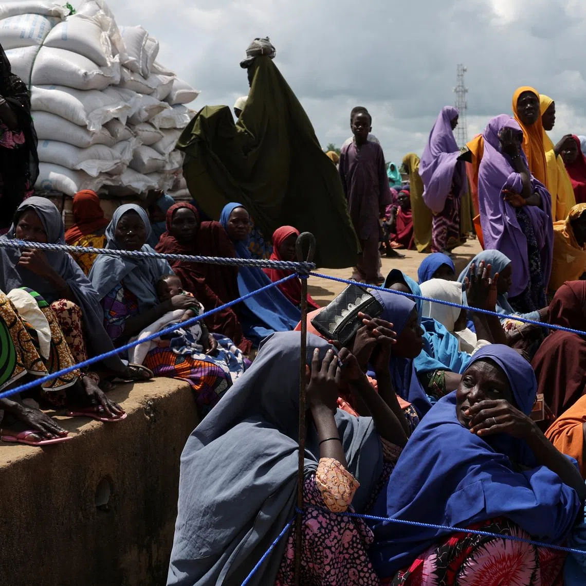 Beneficiaries from different Internally Displaced Persons camps wait to receive support following the exit of USAID, at a World Food Programme distribution centre in Dikwa, Borno State, Nigeria, August 27, 2025. REUTERS/Sodiq Adelakun.