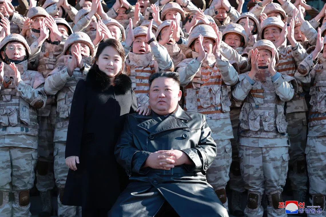 epa10331637 An undated photo released by the official North Korean Central News Agency (KCNA) on 27 November 2022 shows North Korean leader Kim Jong-un (front, C) posing with his daughter, presumed to be his second child, Ju-ae (C-L), during a photo session with the contributors to the successful test-fire of new-type ICBM Hwasongpho-17 at an undisclosed location in North Korea.  EPA-EFE/KCNA   EDITORIAL USE ONLY