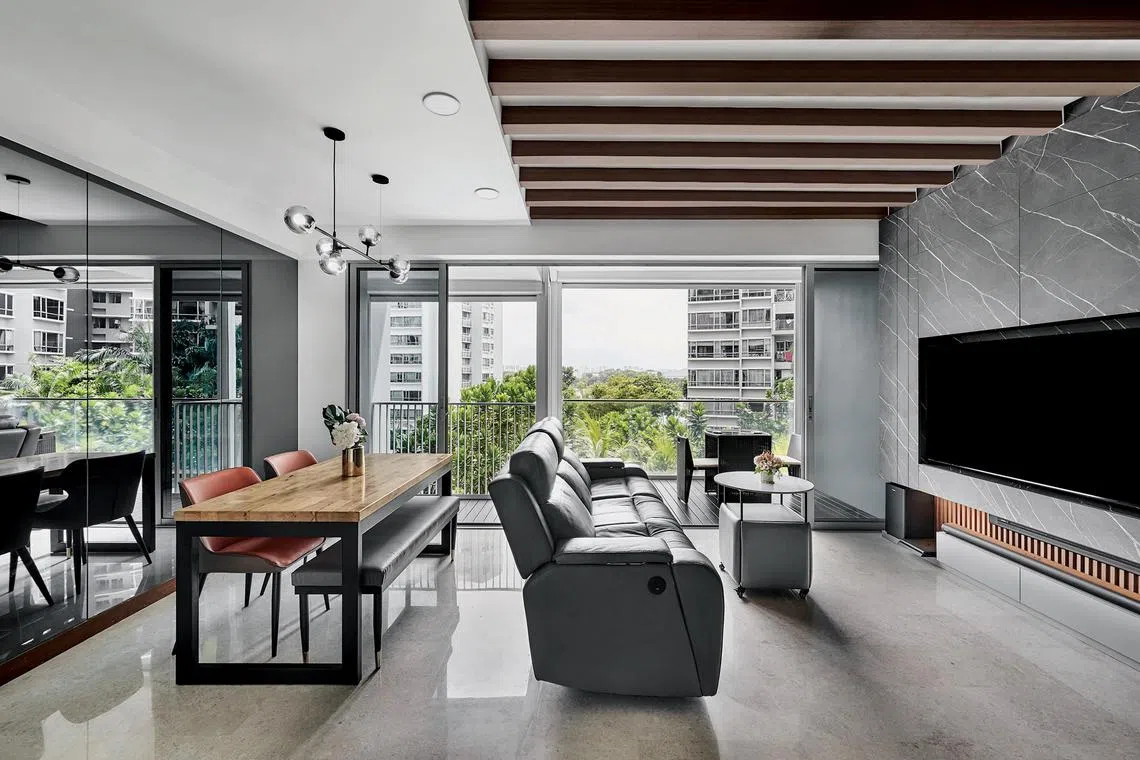 Decorative wooden beams on the ceiling give the living room a warm feel.