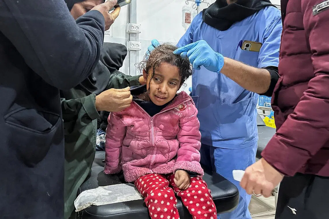 A wounded Palestinian child receives treatment at a hospital, in the aftermath of an Israeli strike, amid the ongoing conflict between Israel and Hamas, in Nuseirat in the central Gaza Strip, December 20, 2024. REUTERS/Khamis Said