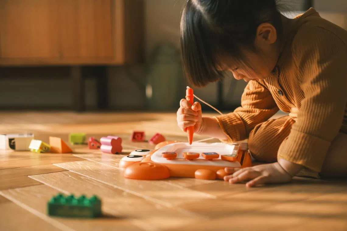 Little girl playing with educational toy as a screen-free alternative