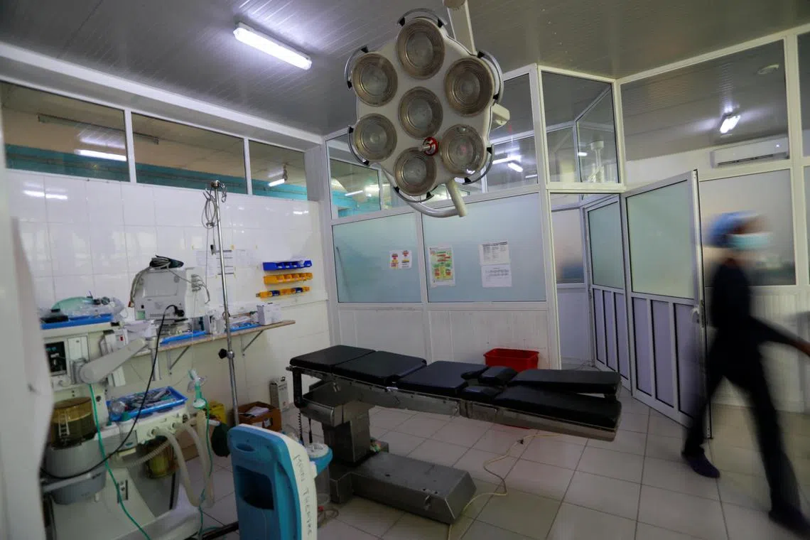 A nurse walks into the operating theatre, where children were treated for Acute Kidney Injury, at the Edward Francis Small Teaching Hospital in Banjul, Gambia, November 4, 2022. In October 2022, the deaths of more than 70 Gambian children from Acute Kidney Injury were linked by global health officials to cough syrups made in India and contaminated with ethylene glycol (EG) and diethylene glycol (DEG).  To match Special Report HEALTH-COUGHSYRUP/ REUTERS/ Edward McAllister