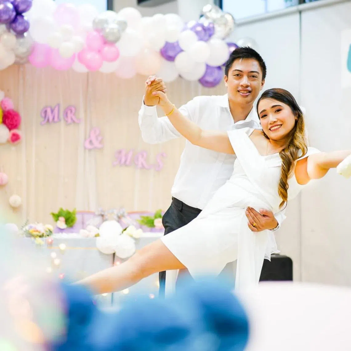 tlmarriage09 - Mr Naldoza Jan Figueroa holds Ms Magtoles Hanna Mae Mondejar in his arms while posing for a wedding photograph at NTUC Health Nursing Home (Jurong West).




Credit : NTUC Health