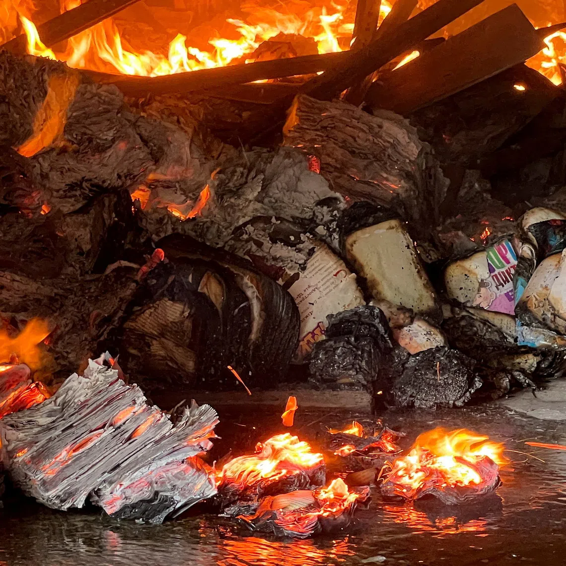 FILE PHOTO: Books burn at the site of a book warehouse hit by a Russian drone strike, amid Russia's attack on Ukraine, in Kharkiv, Ukraine, August 1, 2026. REUTERS/Volodymyr Pavlov/File Photo