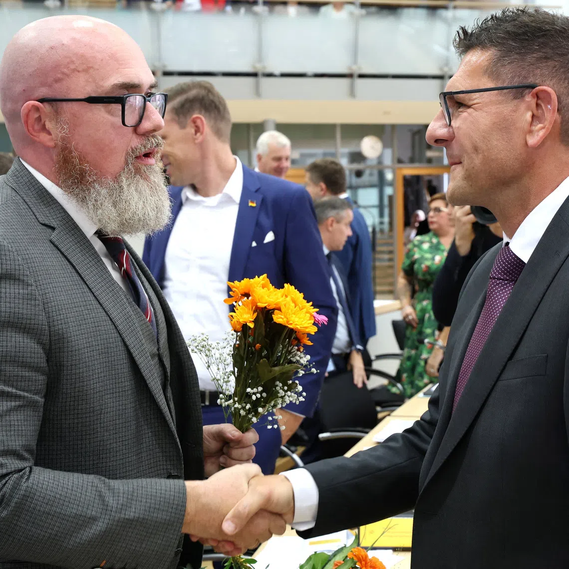 Thomas Schulze from the Buendnis Sahra Wagenknecht (Sahra Wagenknecht Alliance - BSW) congratulates Hans-Thomas Tillschneider from the far-right Alternative for Germany (AfD) party after he was elected vice-president of Saxony-Anhalt's state parliament,  during a session at the State Parliament in Magdeburg, Germany on October 6, 2026. Jan Woitas/Pool via REUTERS