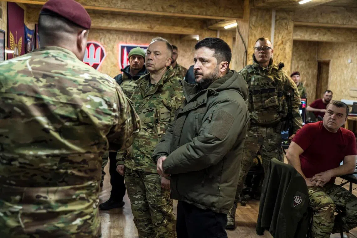 Ukrainian President Volodymyr Zelensky (centre right) and General Oleksandr Syrskyi (centre left) visiting a command post in Ukraine's eastern Donbas region in March 2026.