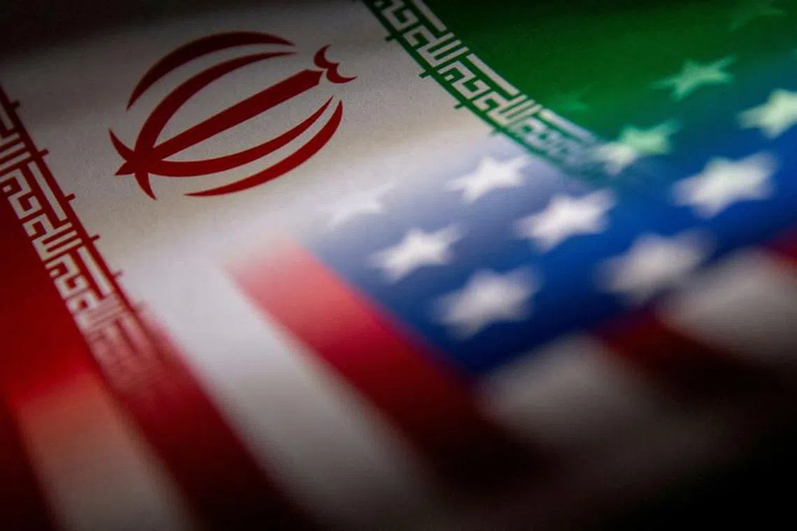FILE PHOTO: Iran's and U.S.'s flags are seen printed on paper in this illustration taken January 27, 2022. REUTERS/Dado Ruvic/Illustration/File Photo