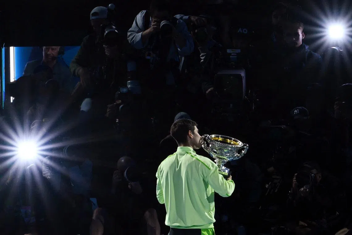 Tennis - Australian Open - Melbourne Park, Melbourne, Australia - February 1, 2026 Spain's Carlos Alcaraz celebrates with the trophy after winning the Australian Open men's singles against Serbia's Novak Djokovic. Alcaraz becomes the youngest man to win all four grand slam titles. REUTERS/Jaimi Joy