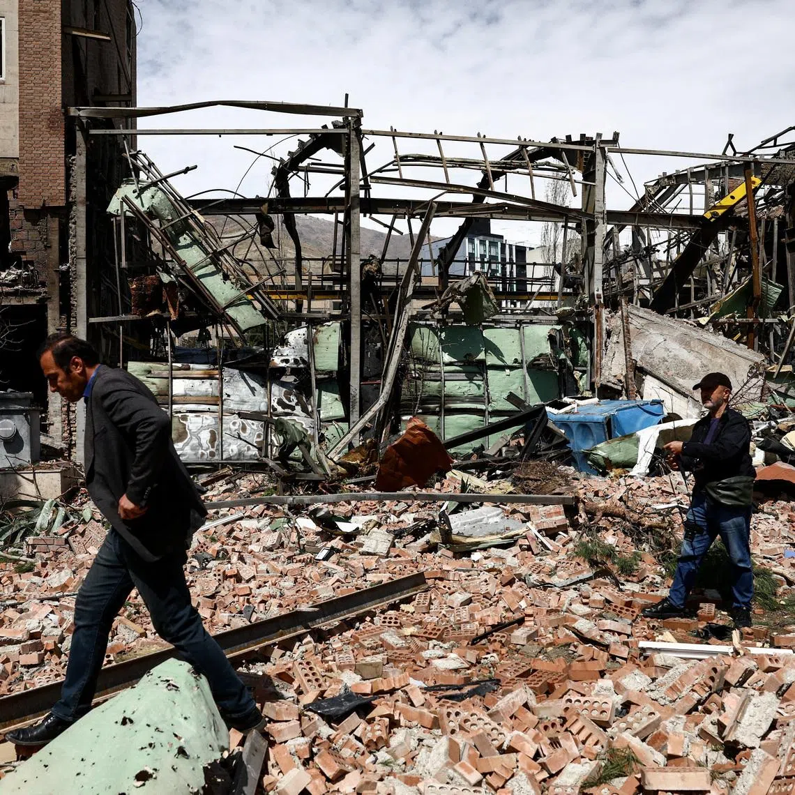 People inspect the damage at the research building of the Shahid Beheshti University, which was damaged by a strike, amid the U.S.-Israeli conflict with Iran, in Tehran, Iran, April 4, 2026.