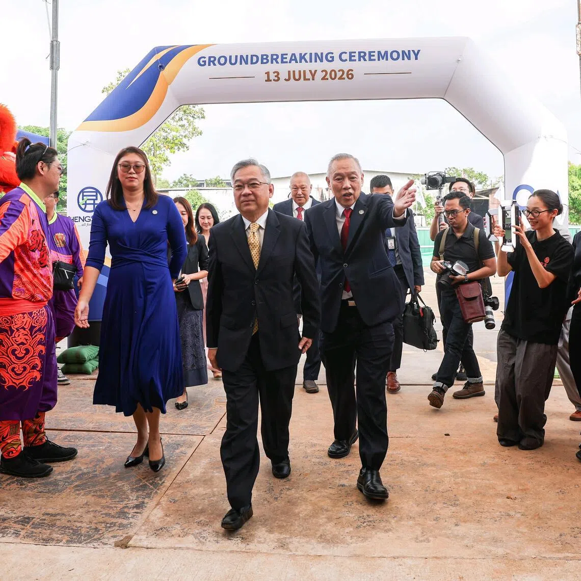 Deputy Prime Minister Gan Kim Yong (centre) and Sheng Siong chief executive Lim Hock Chee (centre, right) arriving at the ground-breaking ceremony for Sheng Siong’s $520 million Integrated Headquarters and Distribution Centre in Sungei Kadut on July 13.