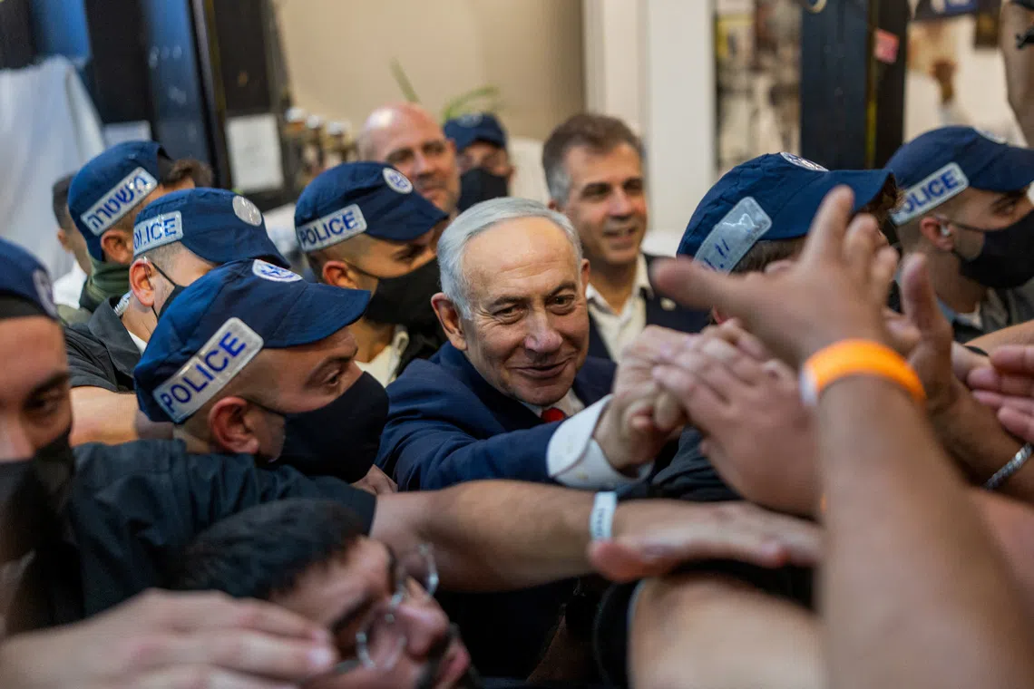 Israeli Prime Minister Benjamin Netanyahu, leader of the Likud party, meets with supporters as he takes part in an election campaign event at Hatikva market, ahead of Israel's national election, in Tel Aviv, Israel, October 22, 2026. REUTERS/Itai Ron