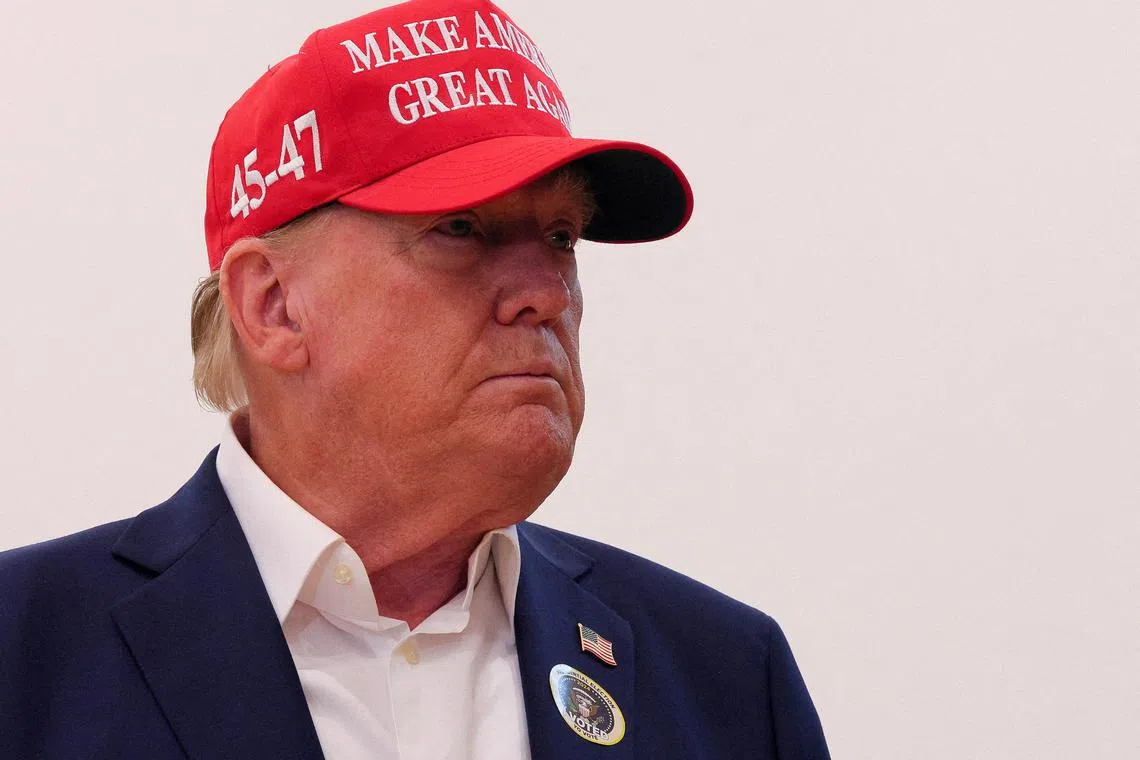 FILE PHOTO: Republican presidential nominee and former U.S. President Donald Trump wears an \"I Voted\" sticker as he speaks to reporters after voting at Mandel Recreation Center on Election Day in Palm Beach, Florida, U.S., November 5, 2024. REUTERS/Brian Snyder/File Photo