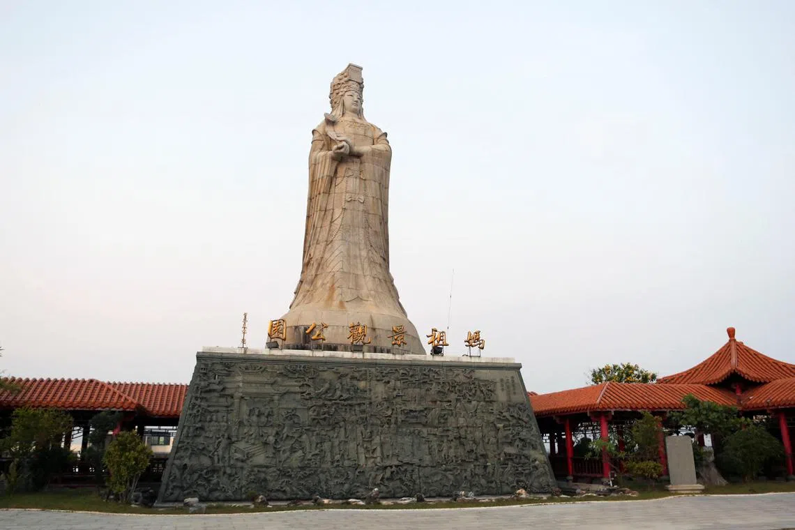 A statue of goddess Mazu stands atop a hill overlooking the Chaotian Mazu Temple in Beigang, Taiwan in Nov 2023.   