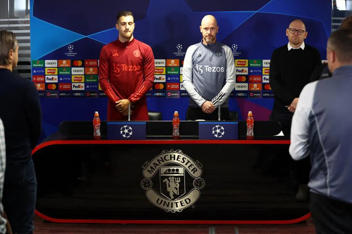 Soccer Football - Champions League - Manchester United Press Conference - Trafford Training Centre, Manchester, Britain - October 23, 2023 Manchester United's Diogo Dalot and manager Erik ten Hag hold a minutes silence in memory of former player Bobby Charlton before the press conference REUTERS/Carl Recine