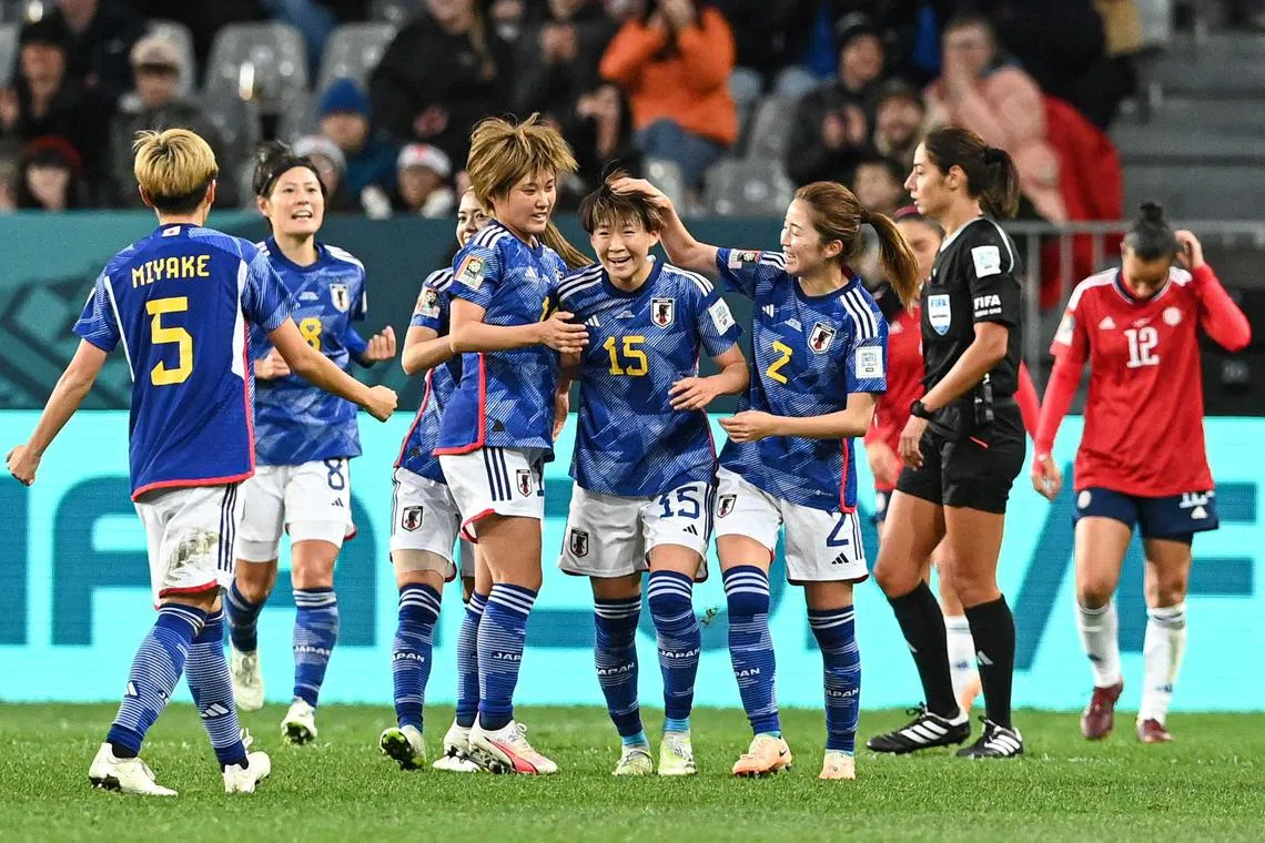 Japan's midfielder Aoba Fujino (centre) celebrates scoring her team's second goal in the 2-0 win over Costa Rica.