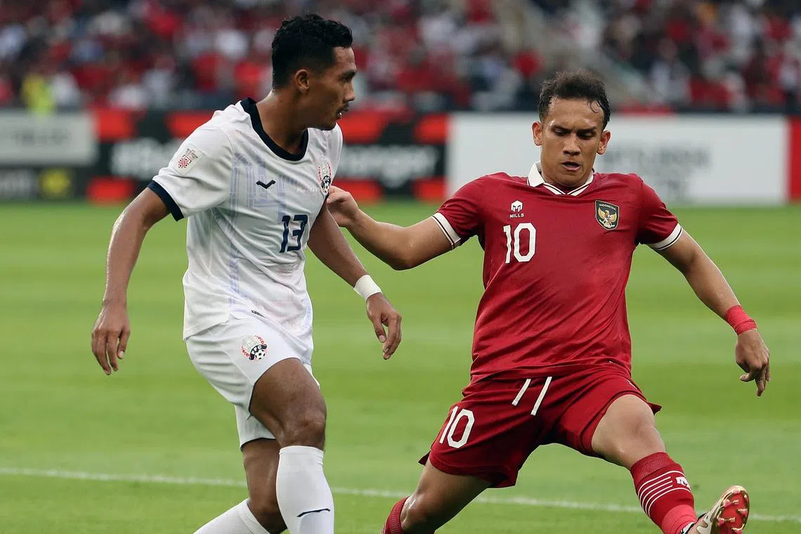Cambodia's Saret Krya (left) and Indonesia's Egy Maulana Vikri in action during their Group A match on Friday.