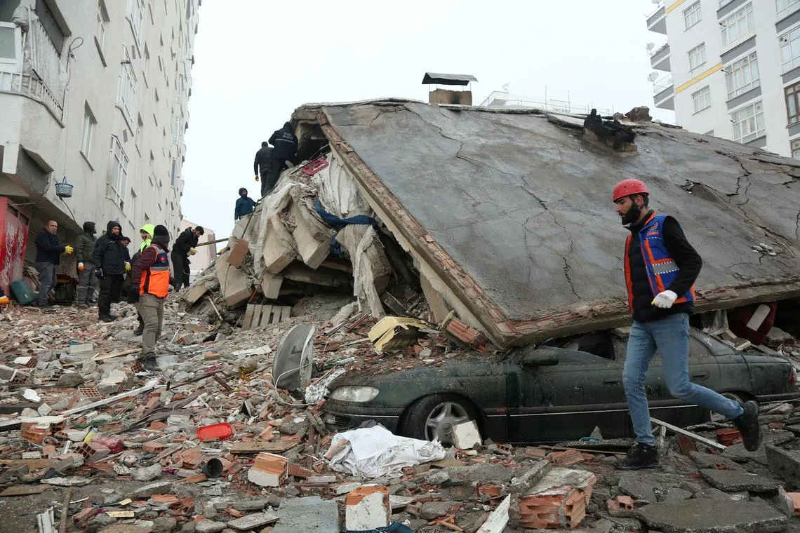 Rescuers search for survivors under the rubble following an earthquake in Diyarbakir, Turkey, Feb 6, 2023.