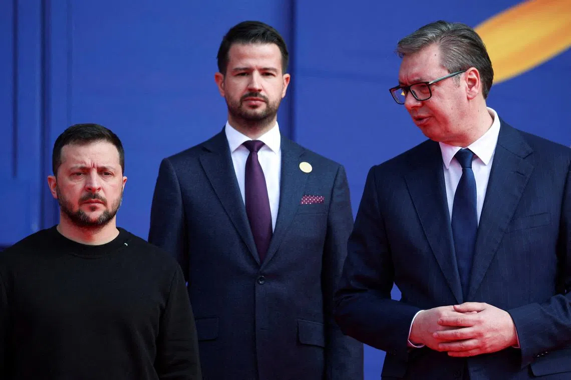 Ukrainian President Volodymyr Zelenskiy, Serbian President Aleksandar Vucic and President of Montenegro Jakov Milatovic stand on the day of the Ukraine Southeast Europe Summit in Tirana, Albania, February 28, 2024. REUTERS/Florion Goga