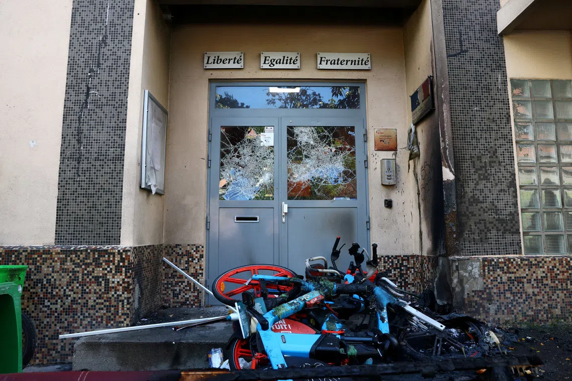 FILE PHOTO: View of the damaged entrance doors of the Lycee Vauquelin high school with bicycles and garbage bins set on fire by protesters in Paris as high school students continue protests in France voicing anger over overcrowded classrooms, teacher shortages and dilapidated school buildings, which students blame on years of underinvestment, continue, France, October 5, 2026. REUTERS/Yves Herman/File Photo