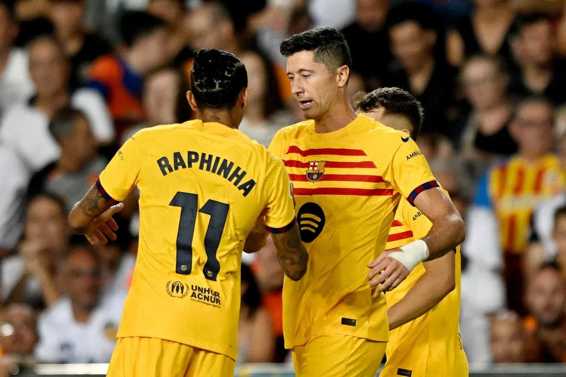 Soccer Football - LaLiga - Valencia v FC Barcelona - Estadio de Mestalla, Valencia, Spain - August 17, 2024 FC Barcelona's Robert Lewandowski celebrates scoring their second goal with FC Barcelona's Raphinha REUTERS/Pablo Morano