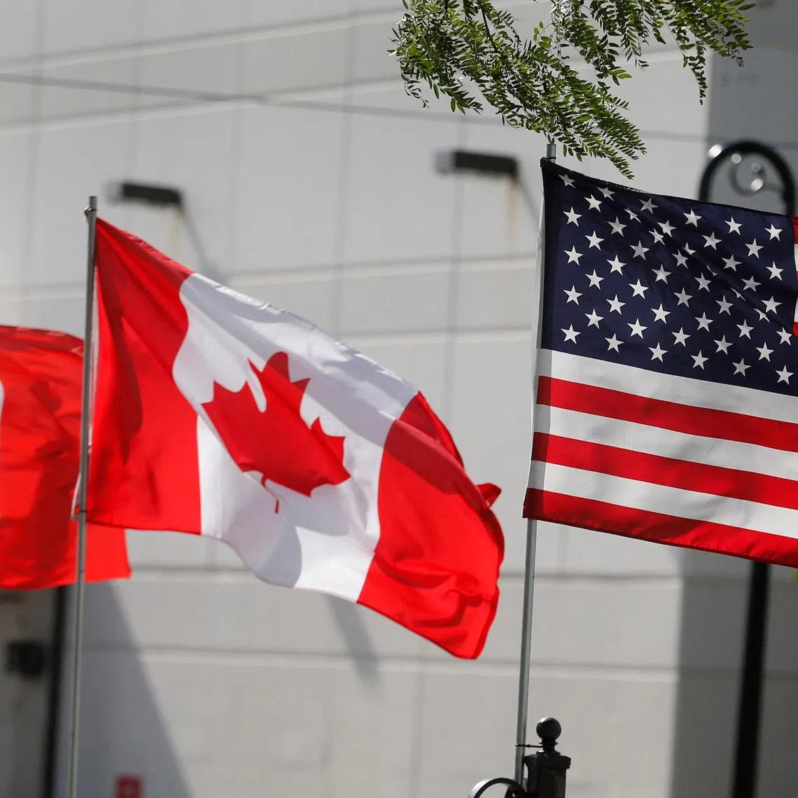 FILE PHOTO: Flags of the U.S., Canada and Mexico fly next to each other in Detroit, Michigan, U.S. August 29, 2018. REUTERS/Rebecca Cook/File Photo