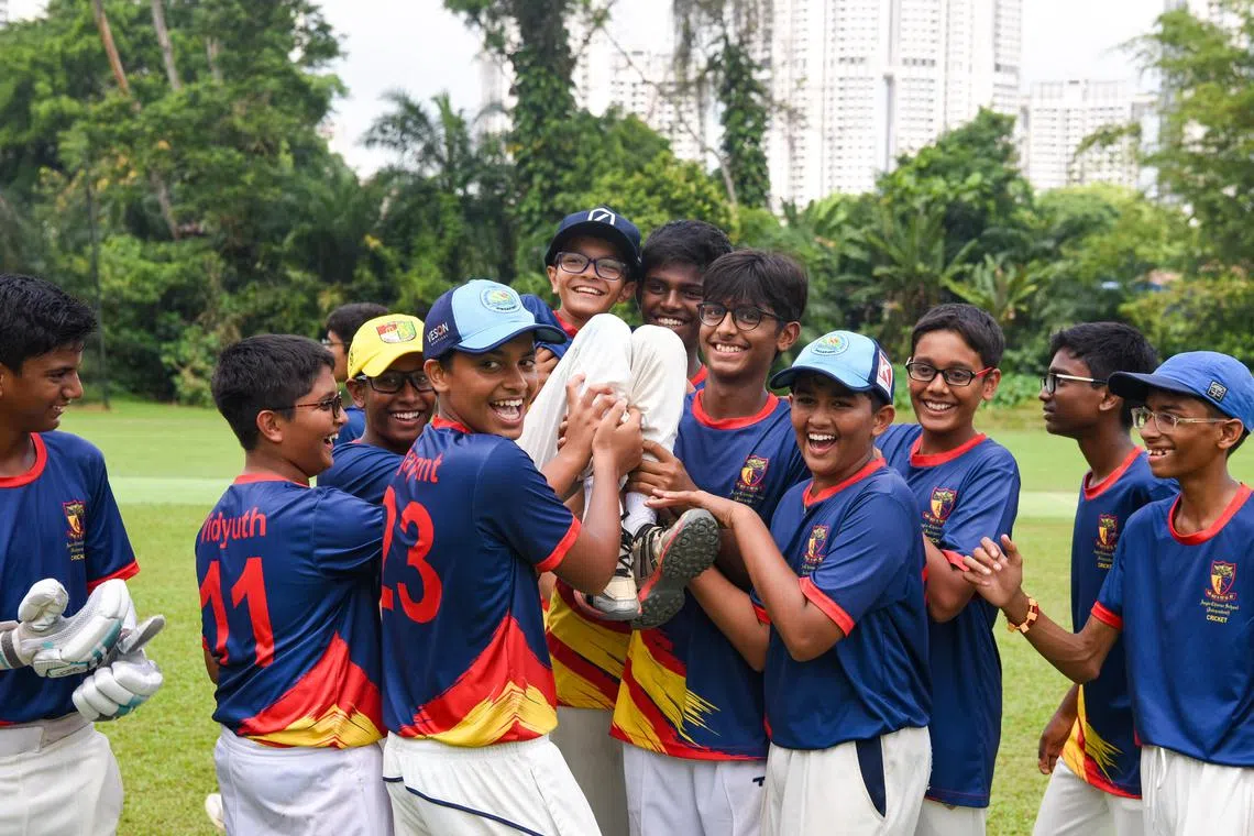 ACSI's cricket team lifting teammate Kiaan Shah, 13, after the C Division boys' final on Wednesday.

ST PHOTO: EUGENE TAN