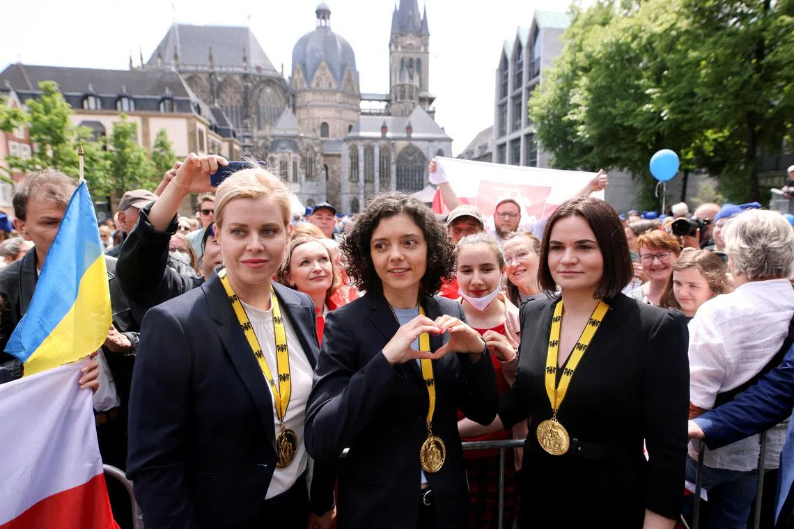 FILE PHOTO: Belarusian civil rights activists Sviatlana Tsikhanouskaya, Veronika Tsepkalo and Tatsiana Khomich, representative of her detained sister Maria Kalesnikava, stand in front of a crowd, outside Aachen Town Hall after the ceremony for the presentation of the Charlemagne Prize (Karlspreis), in Aachen, Germany, May 26, 2022. REUTERS/Thilo Schmuelgen/File Photo