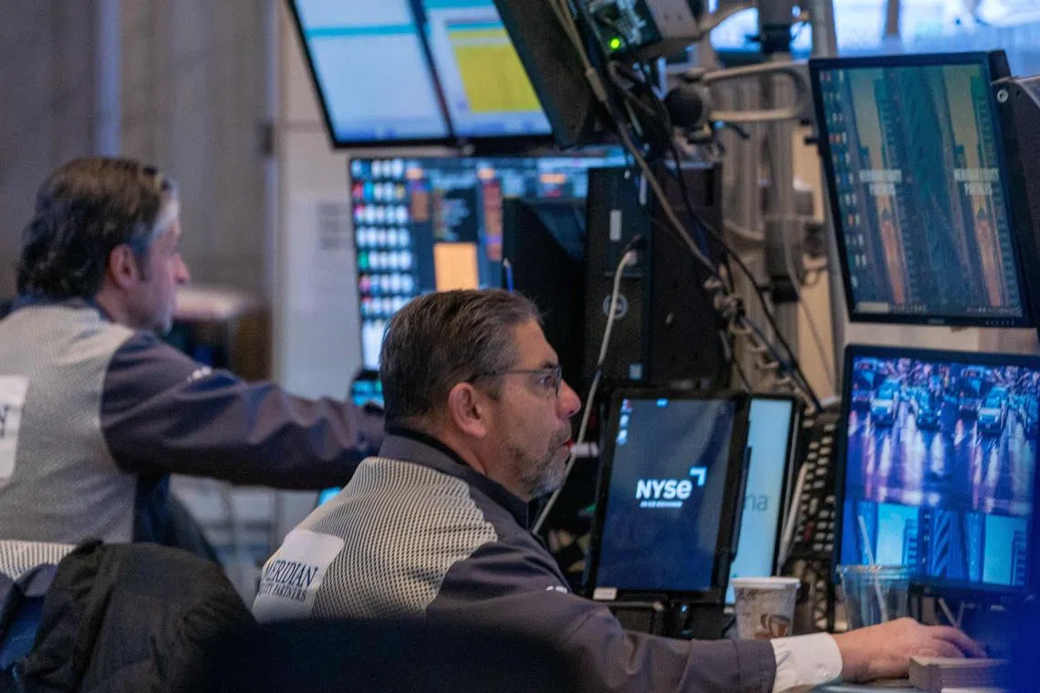 Traders work on the floor of the New York Stock Exchange, in New York City. 