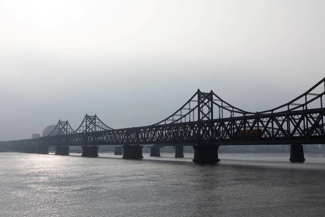 A truck drives along the Friendship Bridge towards North Korea over the Yalu River separating China from the North Korean city of Sinuiju, seen from Dandong, Liaoning province, China, on Jan 15.