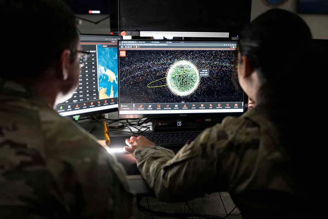U.S. Space Force Guardians assigned to Space Delta 5 monitor computer workstations at Vandenberg Space Force Base, California, U.S., December 18, 2025.  U.S. Space Forces/David Dozoretz/Handout via REUTERS