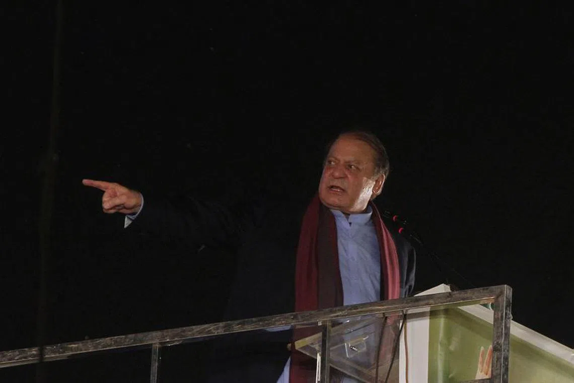 FILE PHOTO: Pakistan's former Prime Minister Nawaz Sharif addresses supporters upon his arrival from a self-imposed exile in London, ahead of the 2024 Pakistani general election, in Lahore, Pakistan October 21, 2023. REUTERS/Mohsin Raza/File Photo