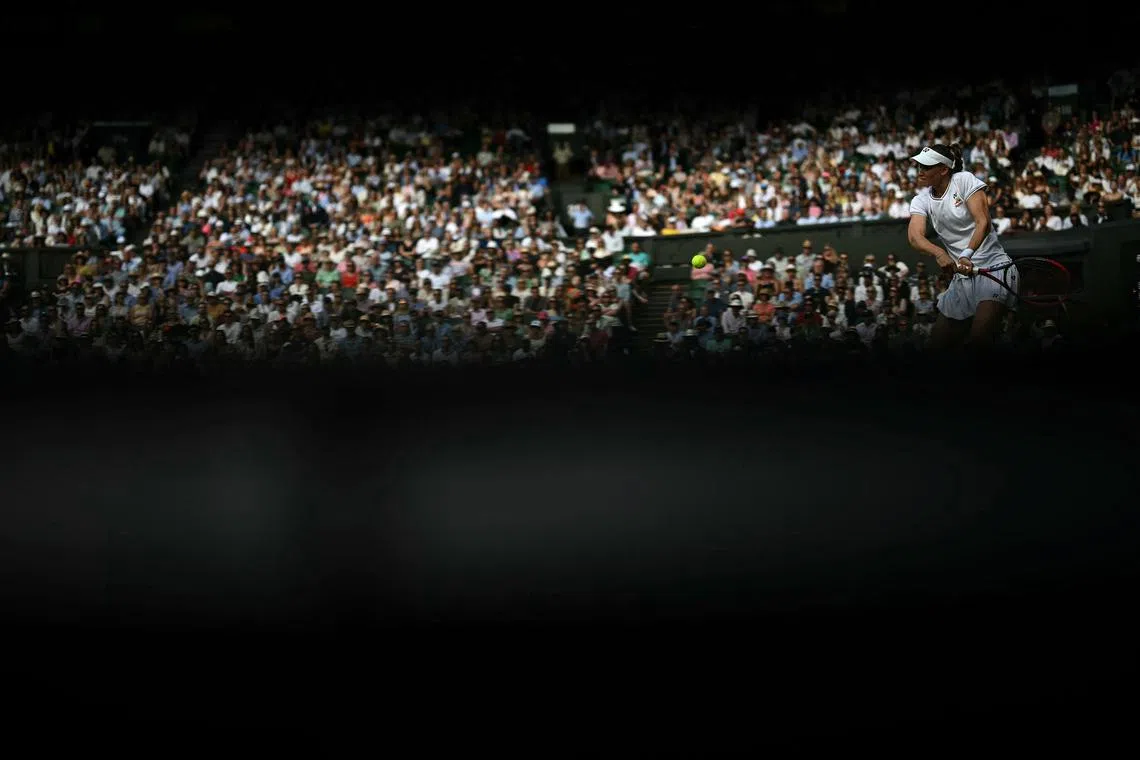 Kazakhstan's Elena Rybakina hitting a return against Czech Republic's Barbora Krejcikova, during their women's singles semi-final tennis match on the eleventh day of the 2024 Wimbledon Championships at The All England Lawn Tennis and Croquet Club in Wimbledon, southwest London, on July 11, 2024. 