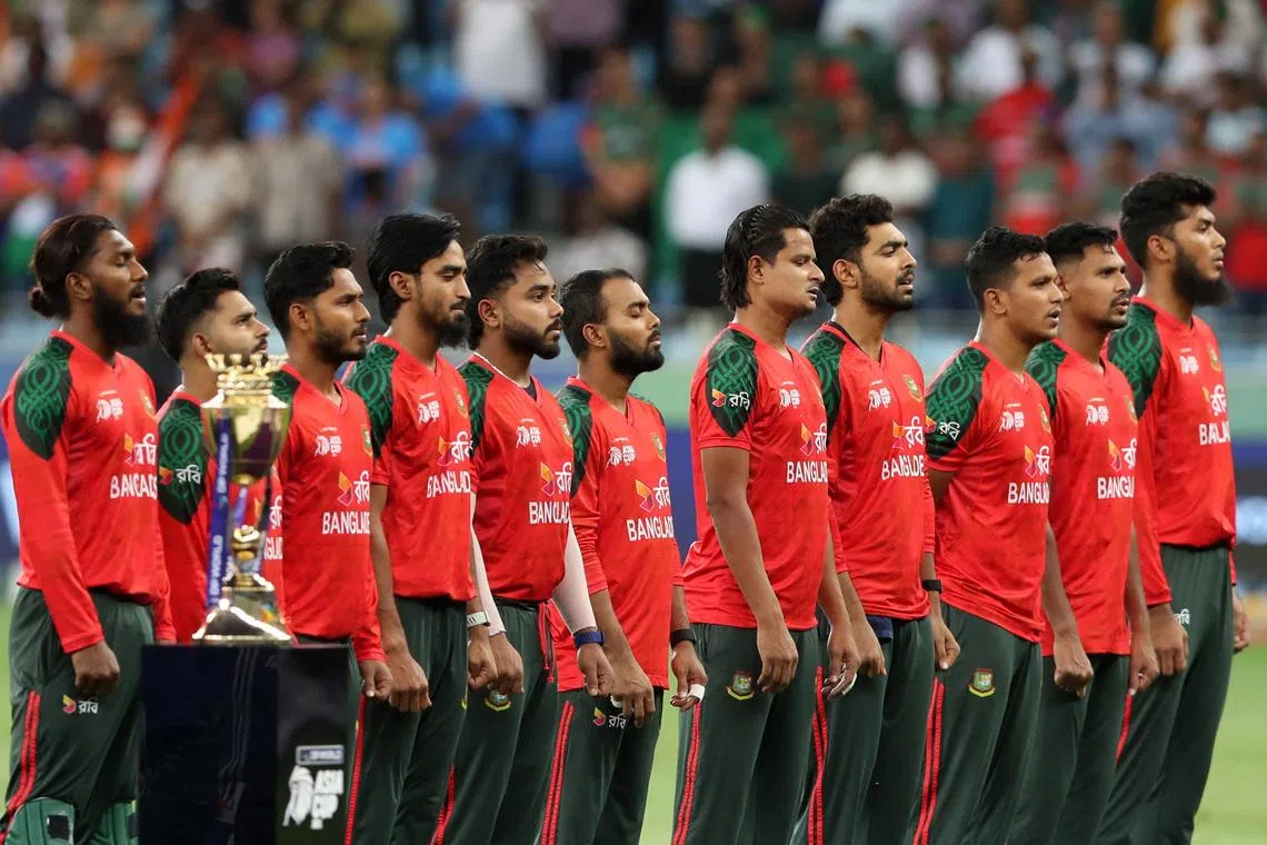 Cricket - Asia Cup - India v Bangladesh - Dubai International Cricket Stadium, Dubai, United Arab Emirates - September 24, 2025  General view of the trophy as the Bangladesh players line up during the national anthems before the match REUTERS/Satish Kumar